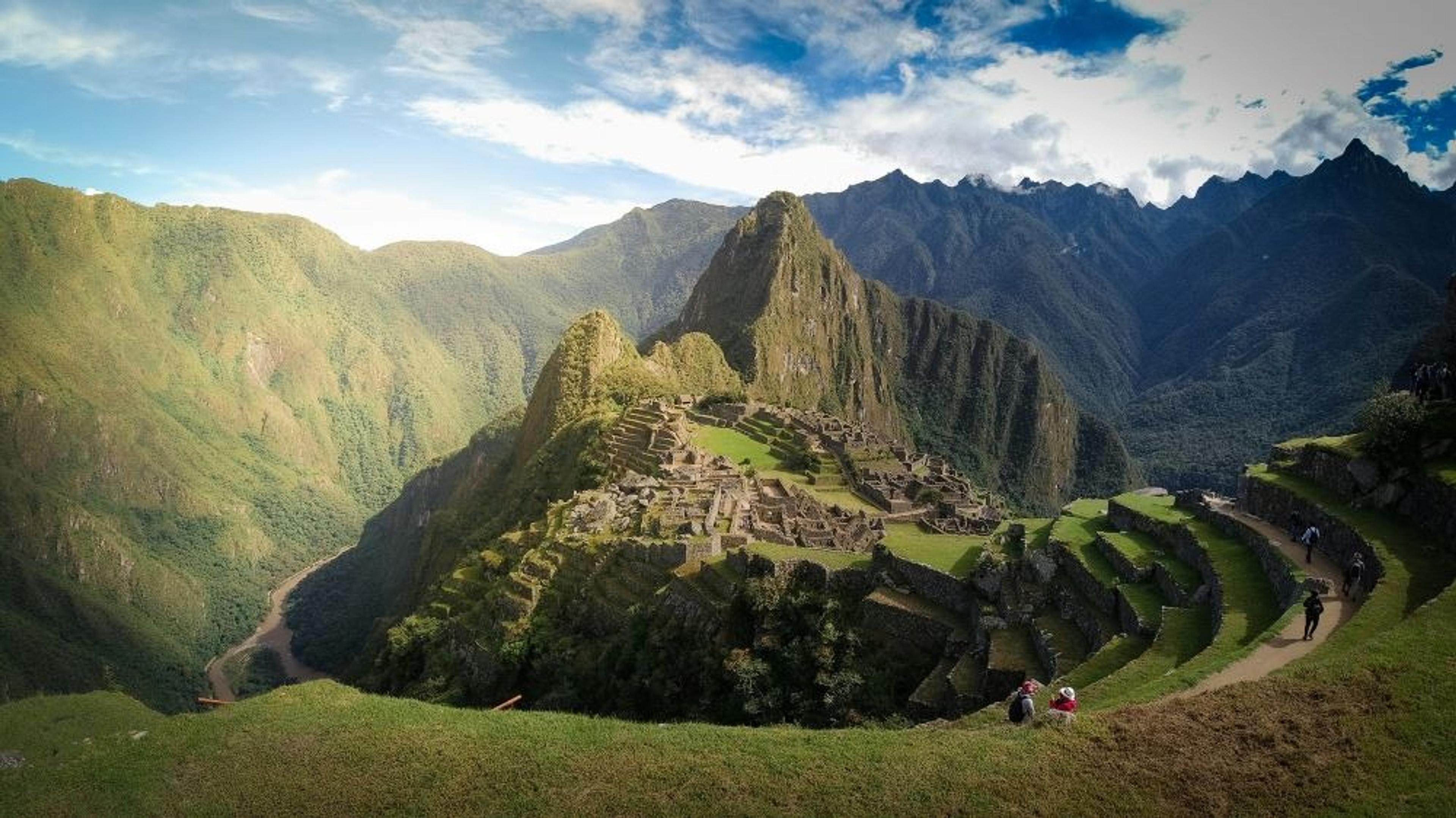 Machu Picchu in Peru features ancient Incan ruins nestled amidst dramatic Andean mountain scenery.