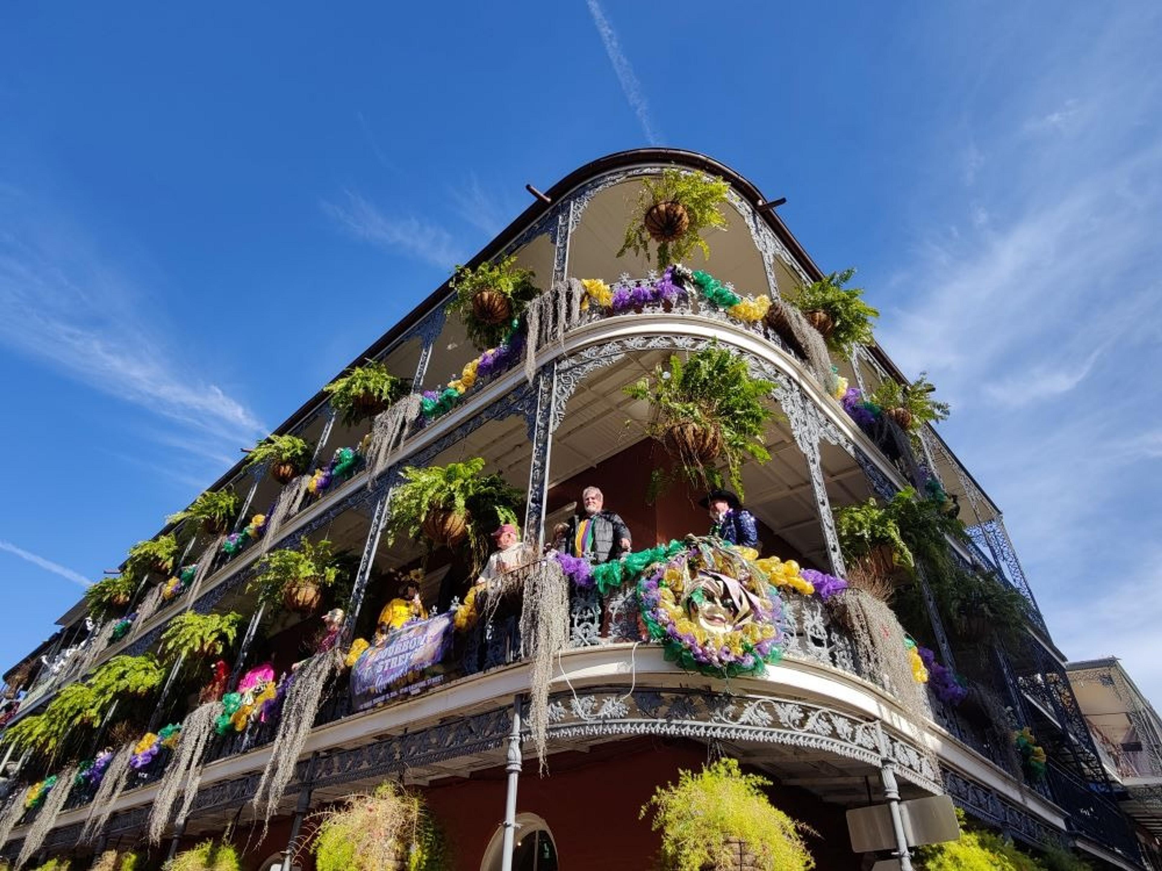 Balconies draped with plants and mardi gras decorations