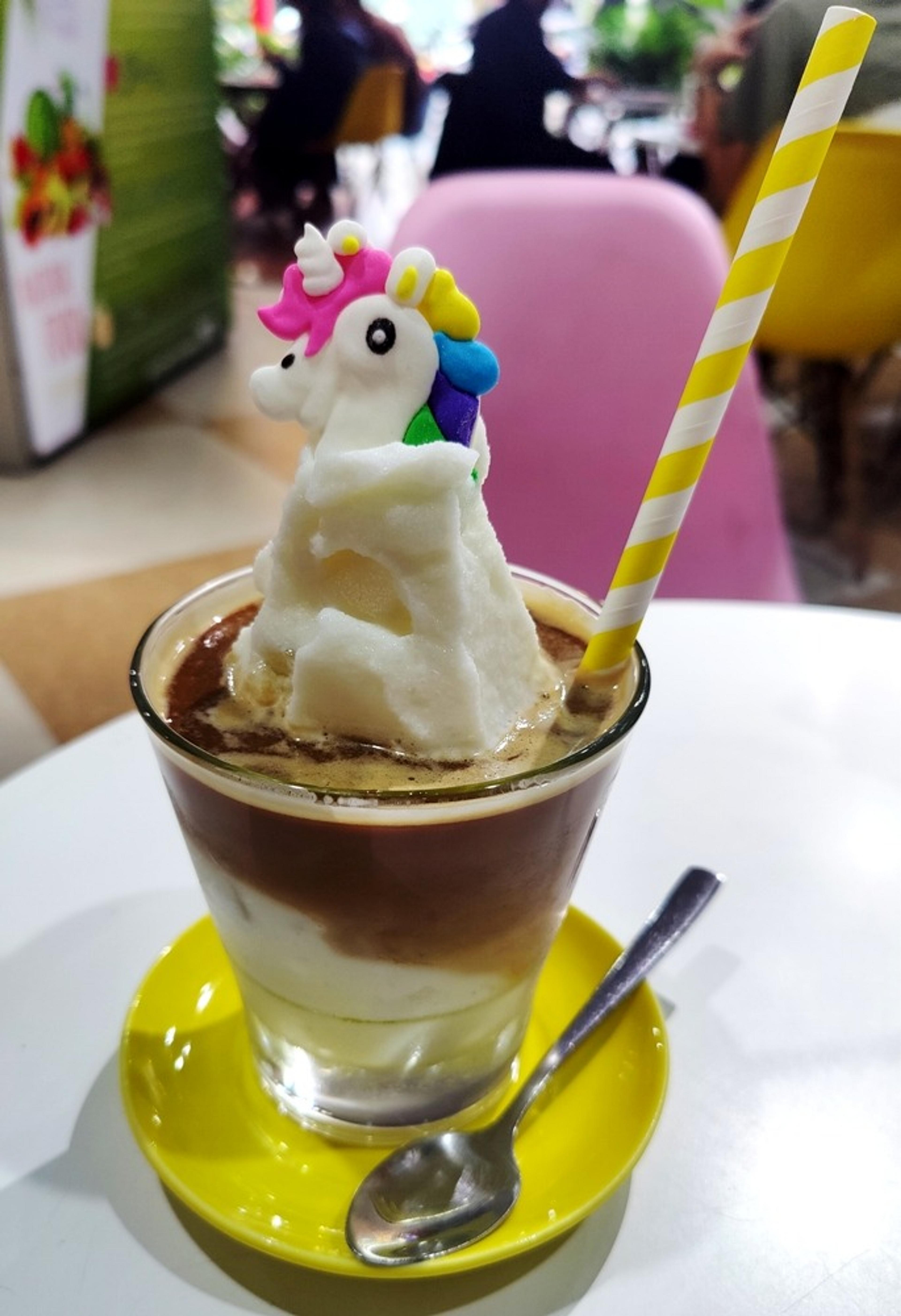Iced coconut coffee with a sugar unicorn on top