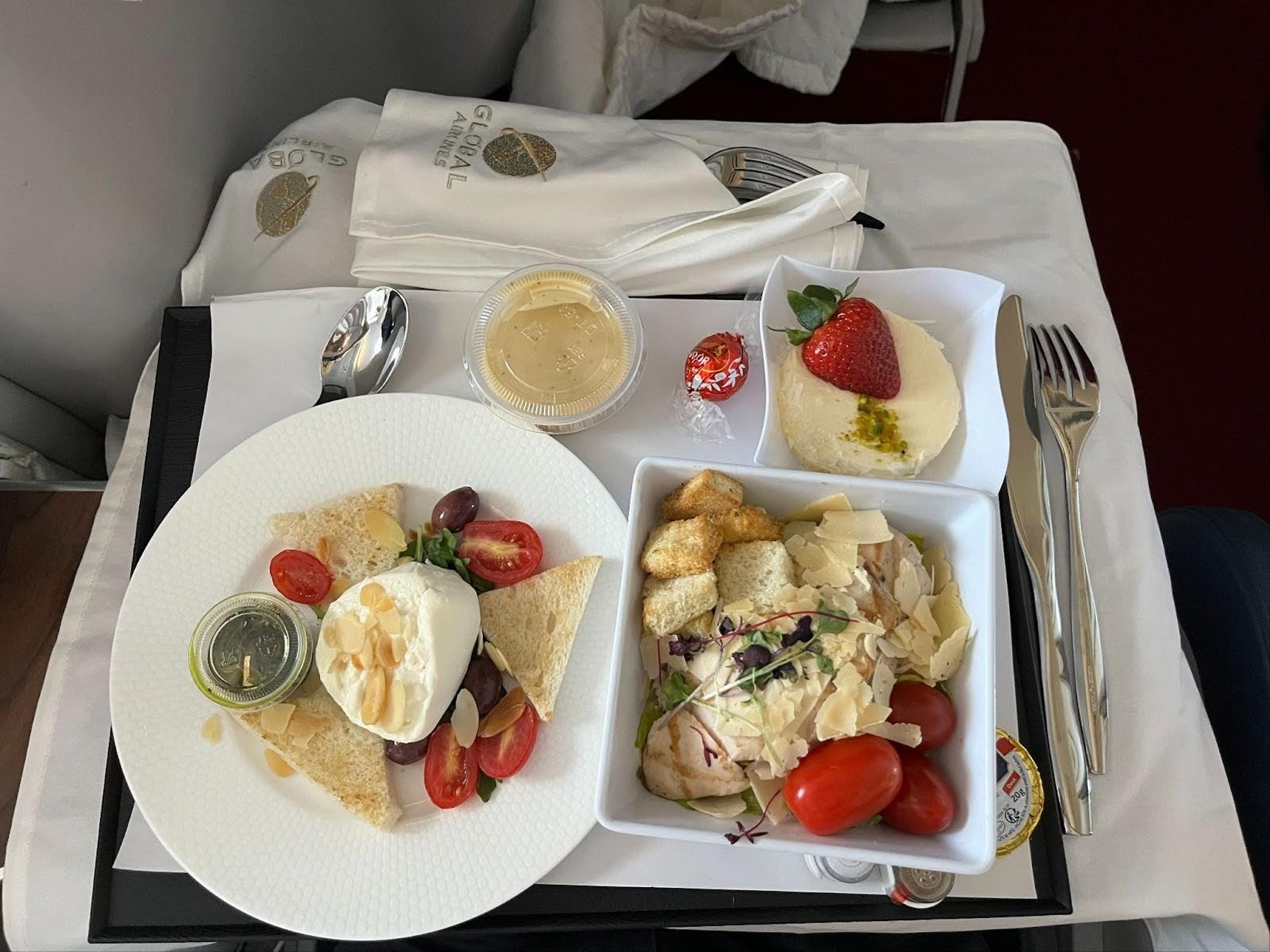 Mozarella ball, chicken & dessert in business class
