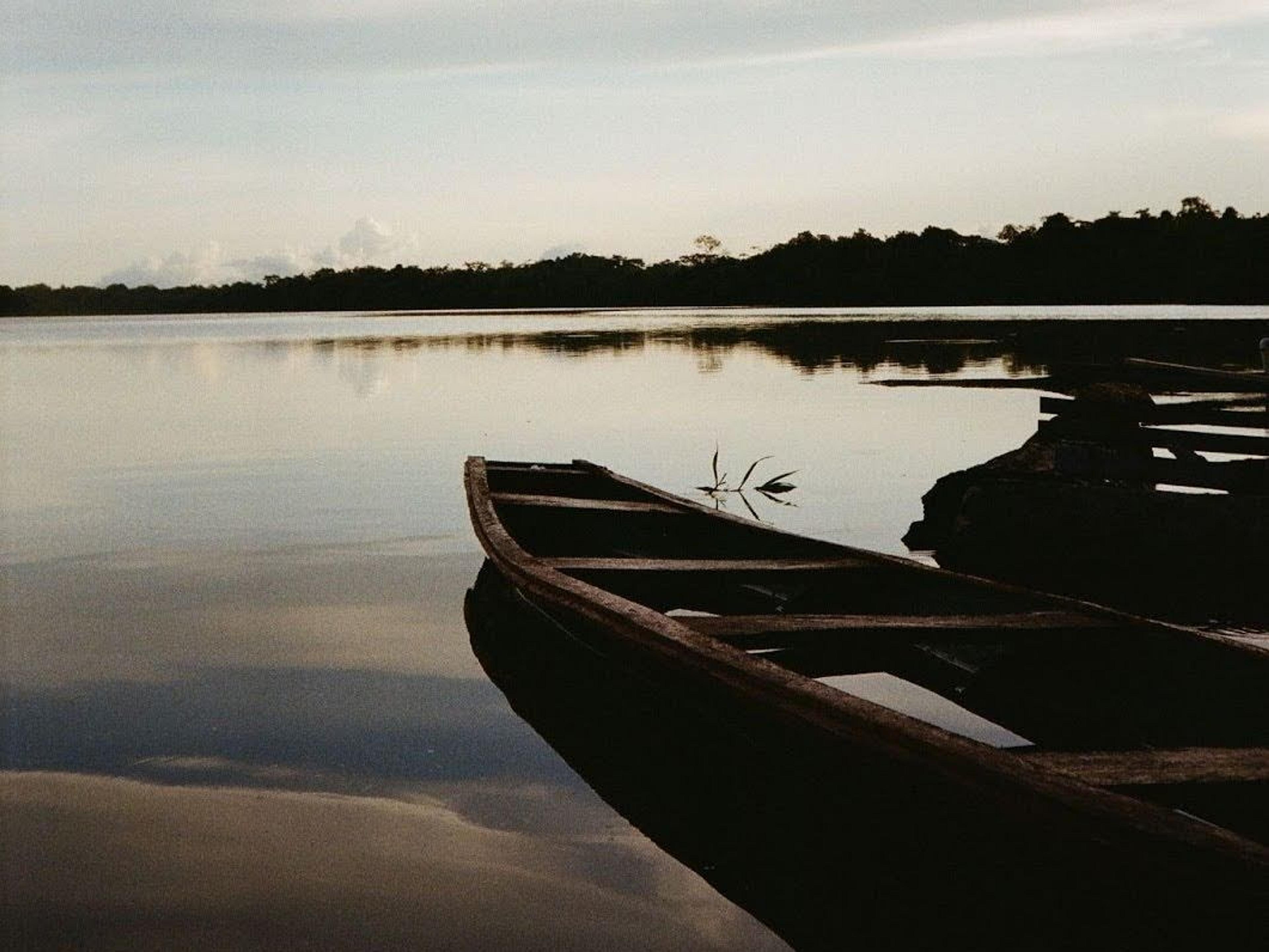Wooden canoe on the still Amazon