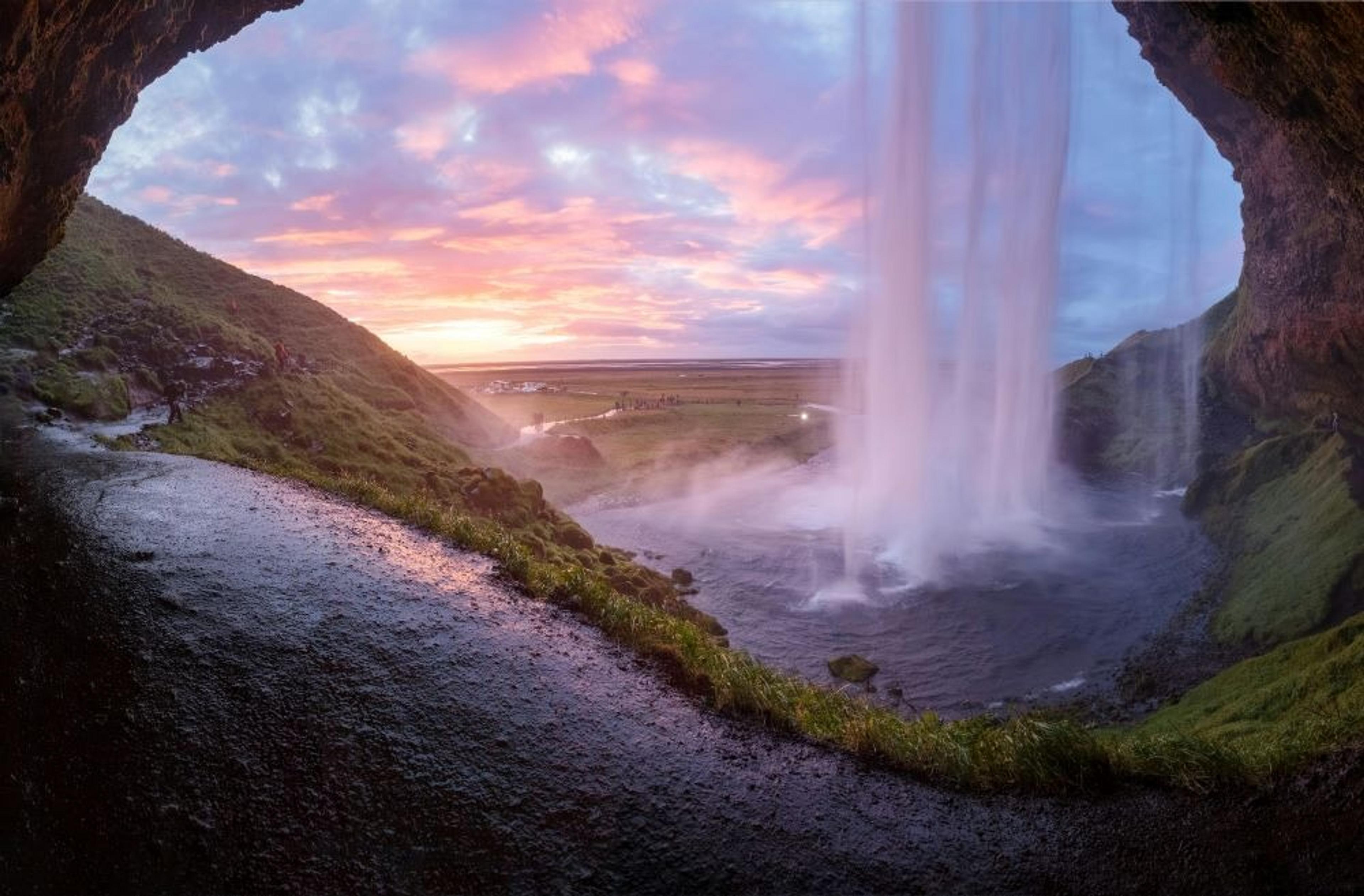 Looking out from inside a cave, behind a waterfall